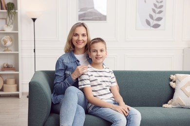 Photo of Mother and son on sofa at home