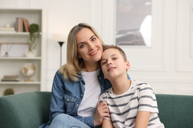 Photo of Mother and son on sofa at home