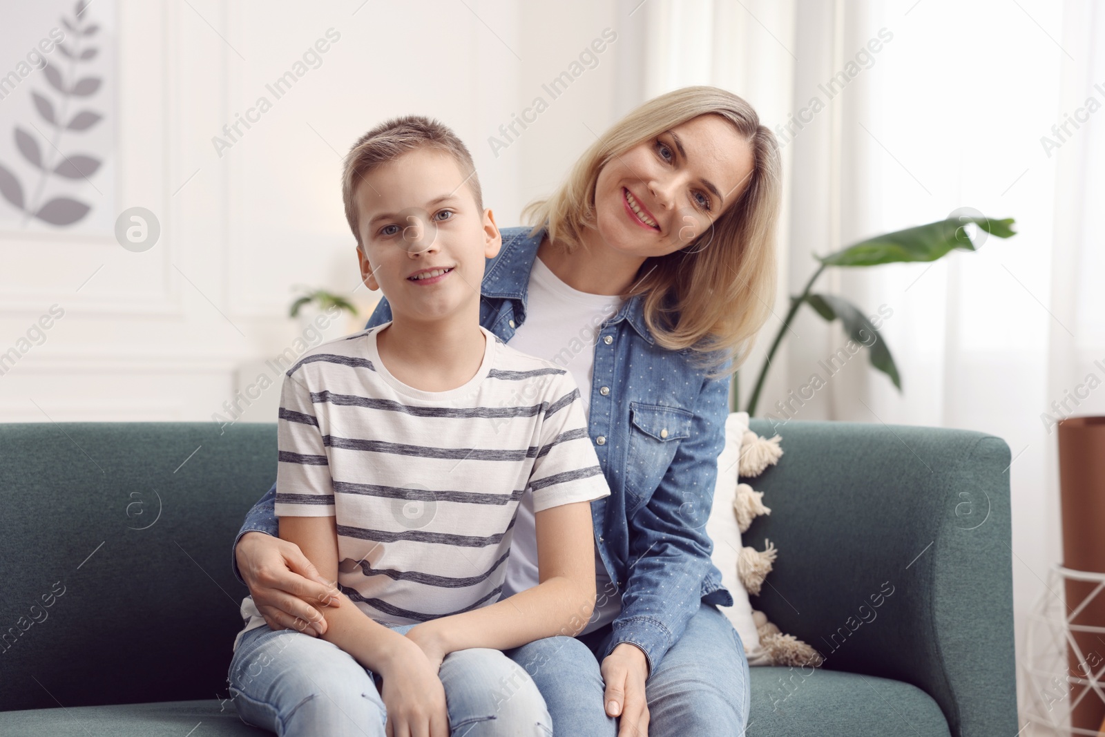 Photo of Mother and son on sofa at home