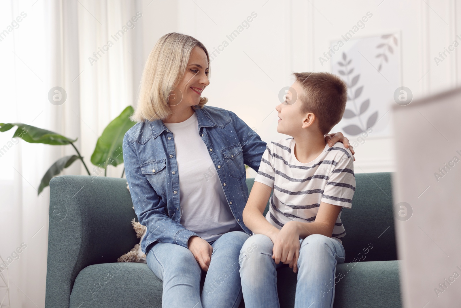 Photo of Mother and son on sofa at home