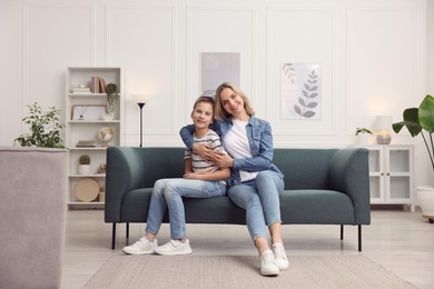 Photo of Mother and son on sofa at home