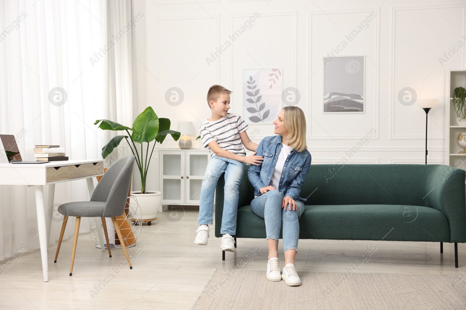 Photo of Mother and son on sofa at home