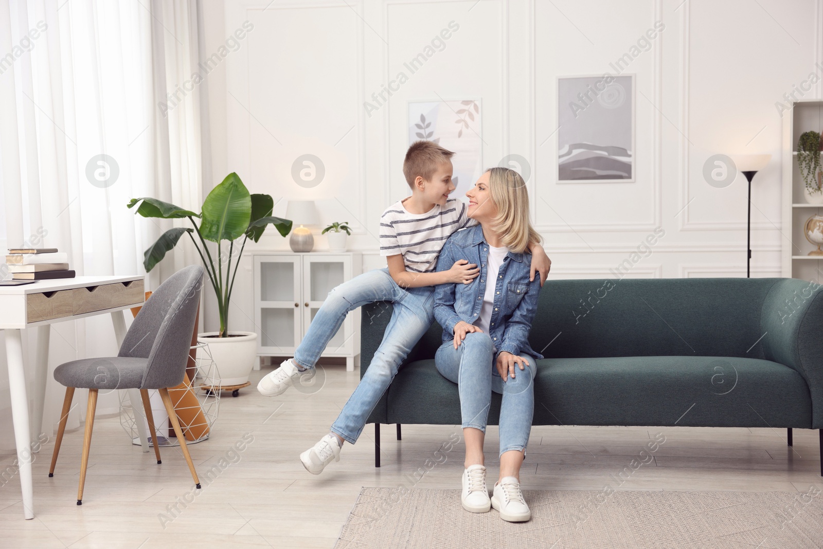 Photo of Mother and son on sofa at home