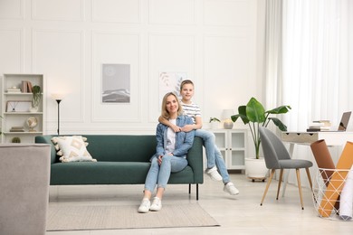 Photo of Mother and son on sofa at home