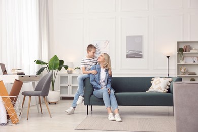 Photo of Mother and son on sofa at home