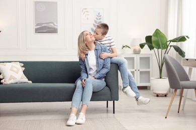 Photo of Mother and son on sofa at home