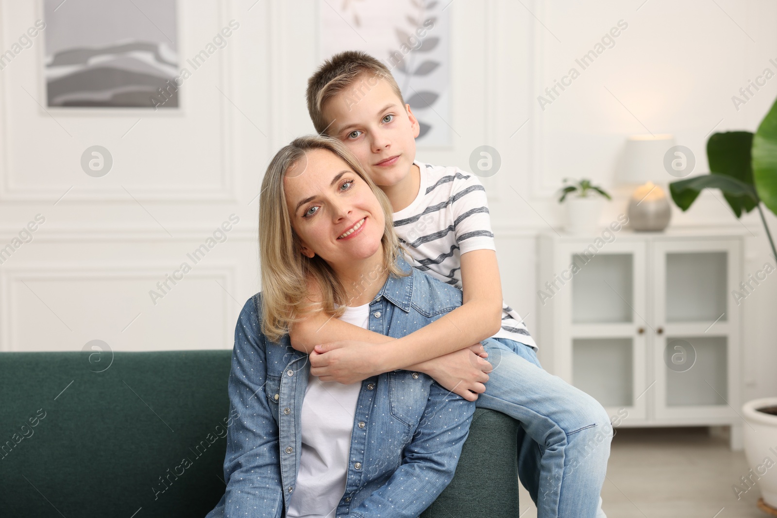 Photo of Mother and son on sofa at home