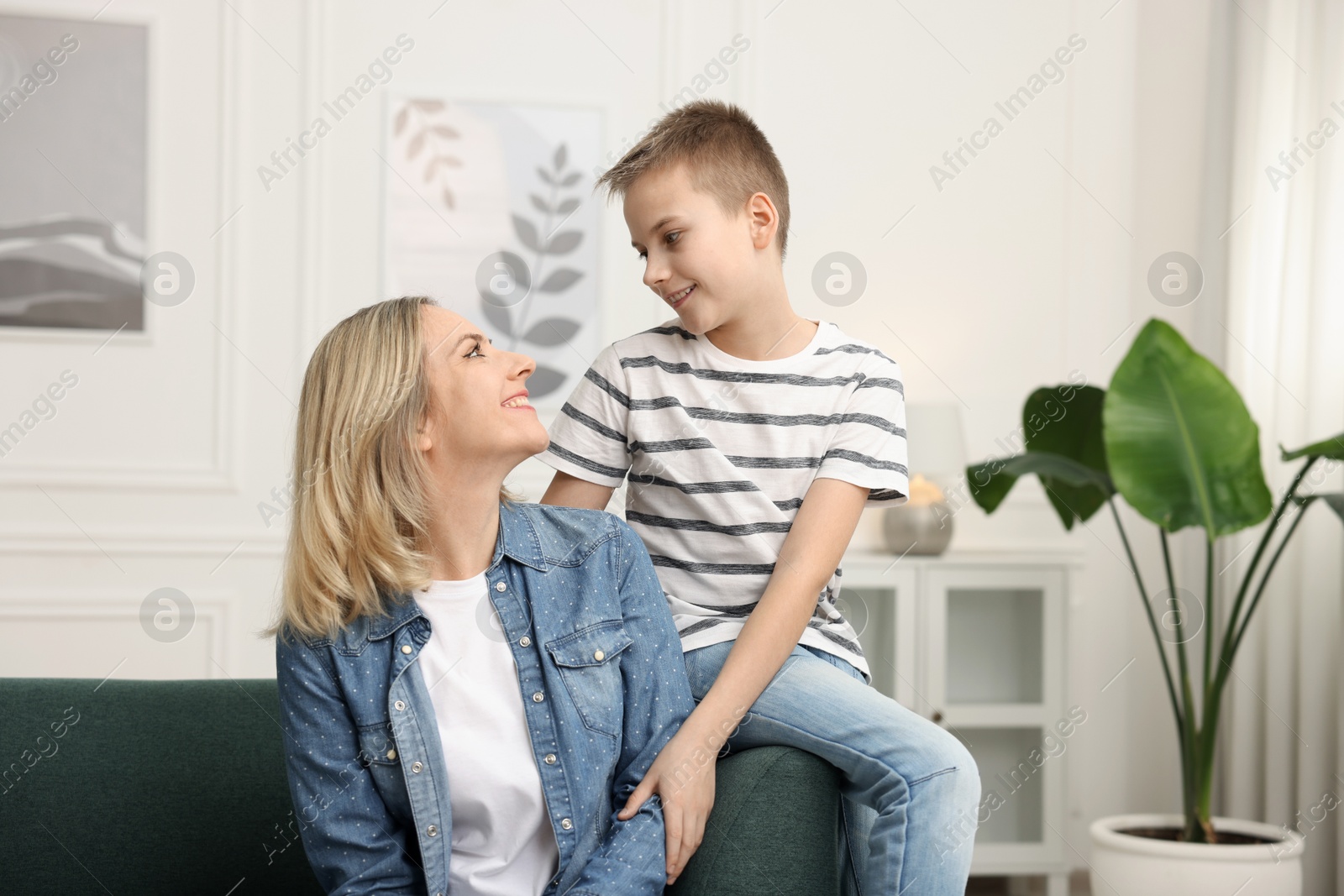 Photo of Mother and son on sofa at home