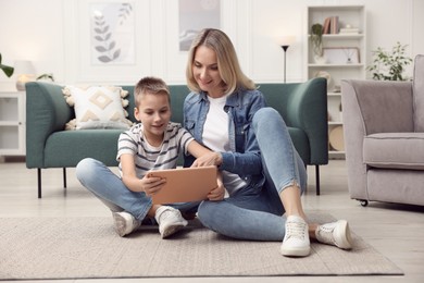 Photo of Mother and son with tablet at home