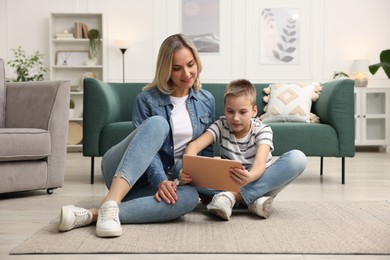 Photo of Mother and son with tablet at home