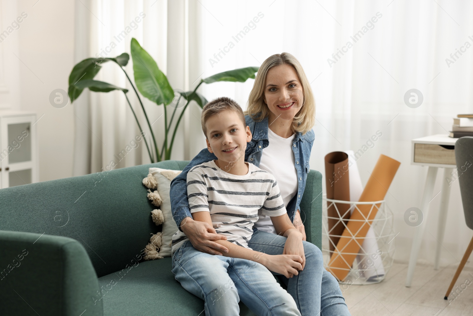 Photo of Mother and son on sofa at home