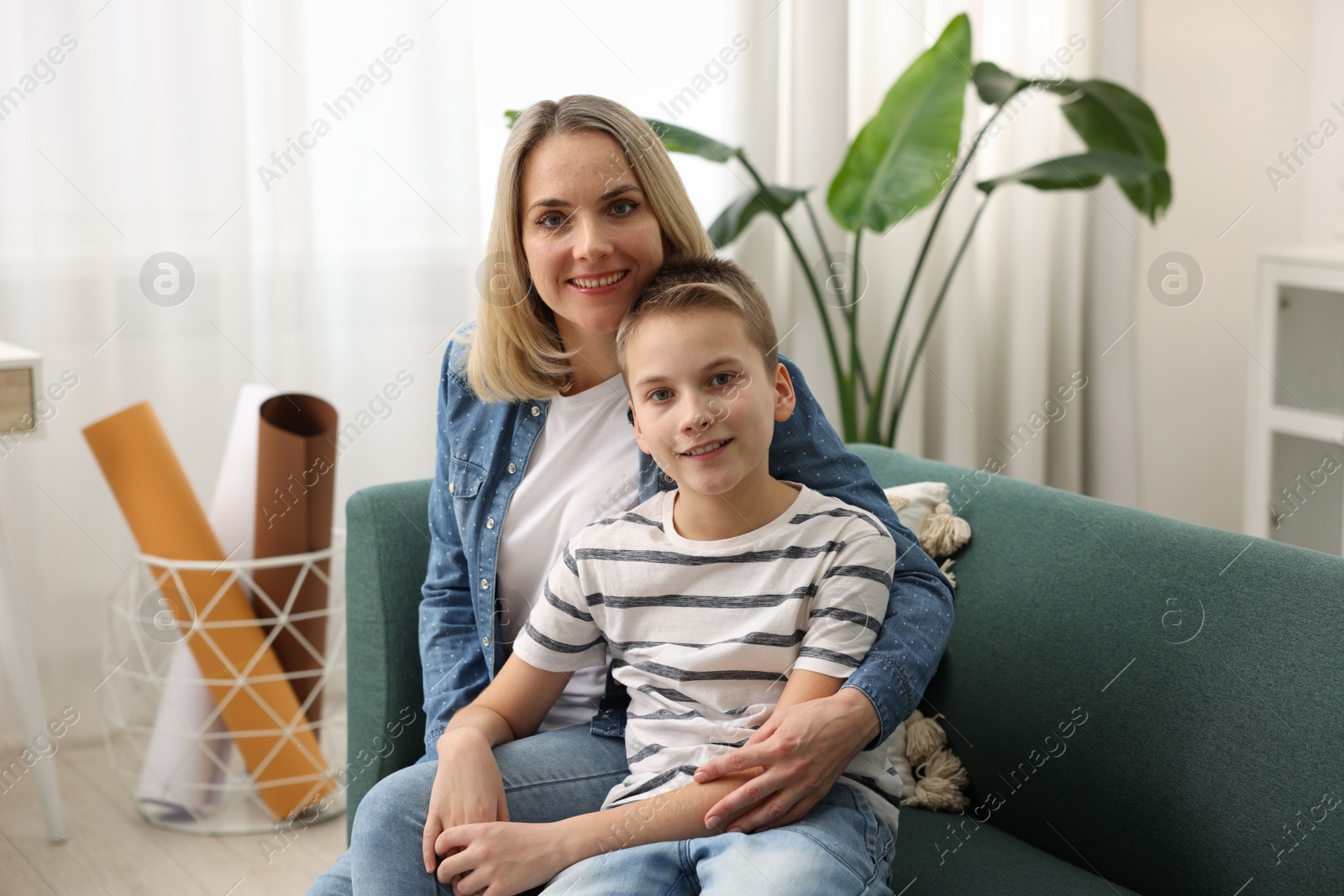 Photo of Mother and son on sofa at home