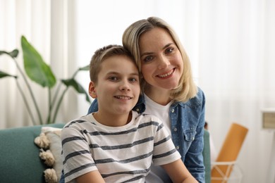 Photo of Mother and son on sofa at home