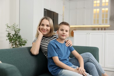 Photo of Mother and son on sofa at home