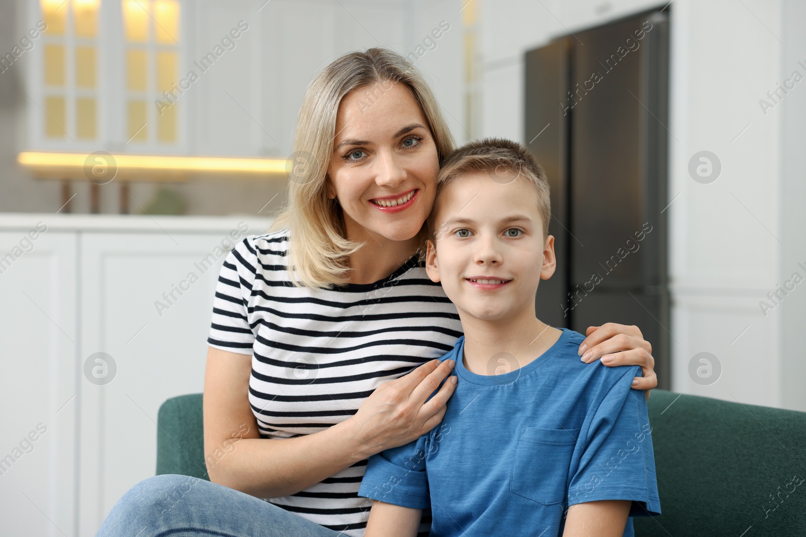 Photo of Mother and son on sofa at home