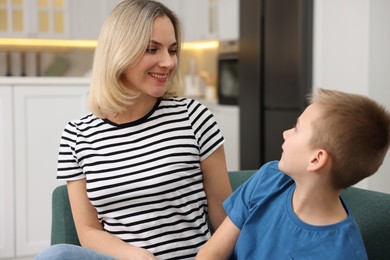 Photo of Mother and son on sofa at home