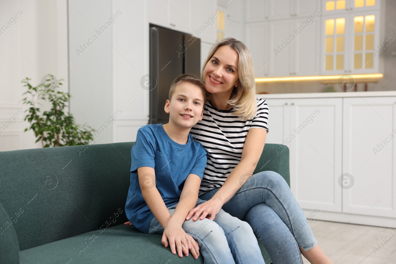 Photo of Mother and son on sofa at home