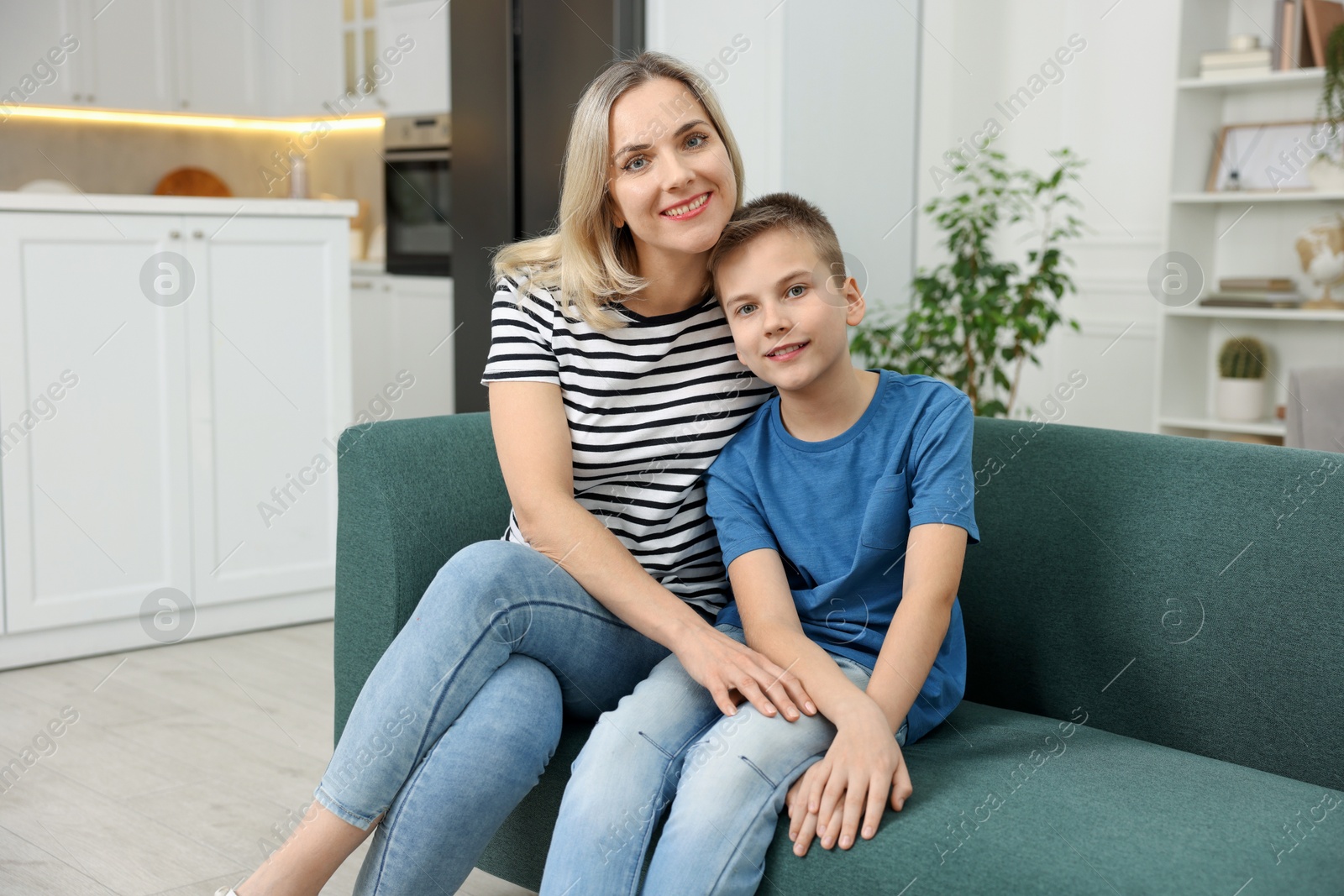 Photo of Mother and son on sofa at home