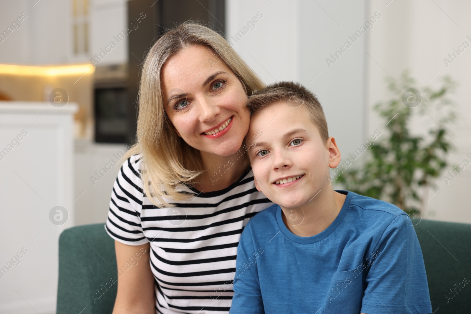 Photo of Mother and son on sofa at home