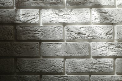 Photo of Light and shadows falling on white brick wall