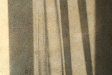 Photo of Light and shadows falling on color textured background