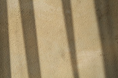 Photo of Light and shadows falling on color textured background