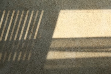 Photo of Light and shadows falling on color textured background