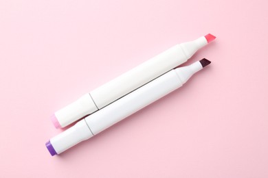 Photo of Two double sided markers on pink background, top view