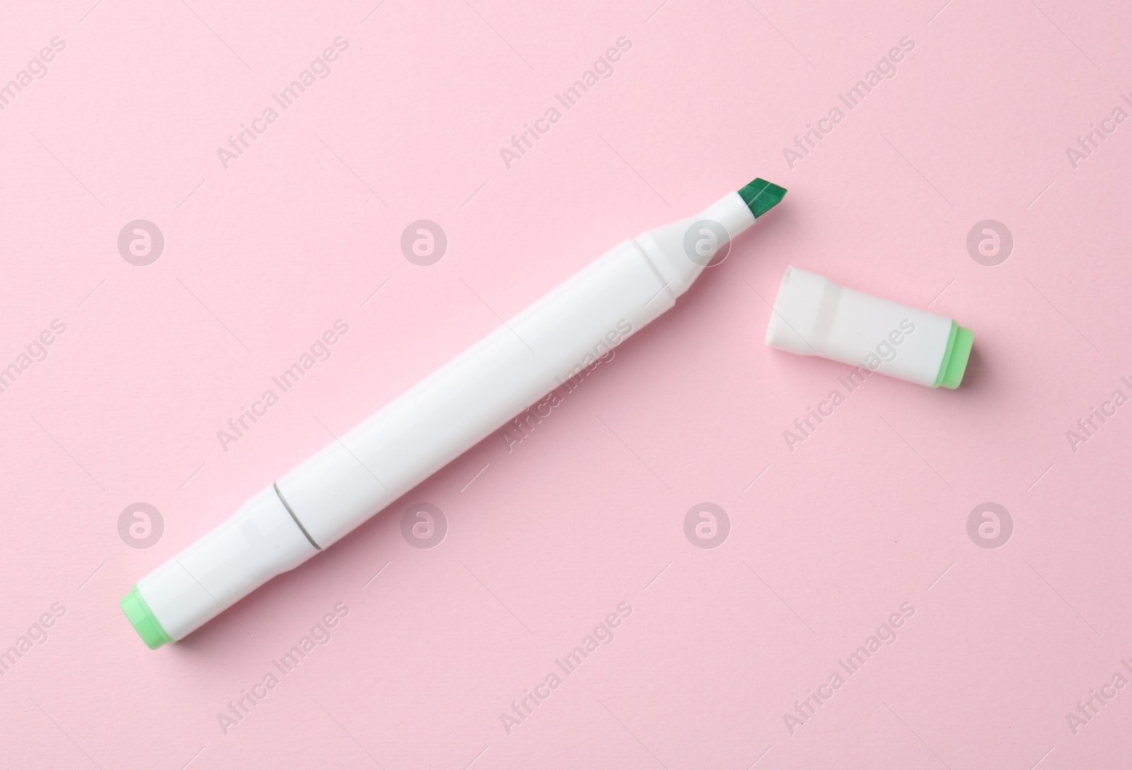 Photo of One green double sided marker on pink background, top view