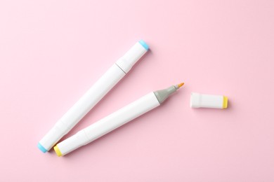 Photo of Two double sided markers on pink background, flat lay