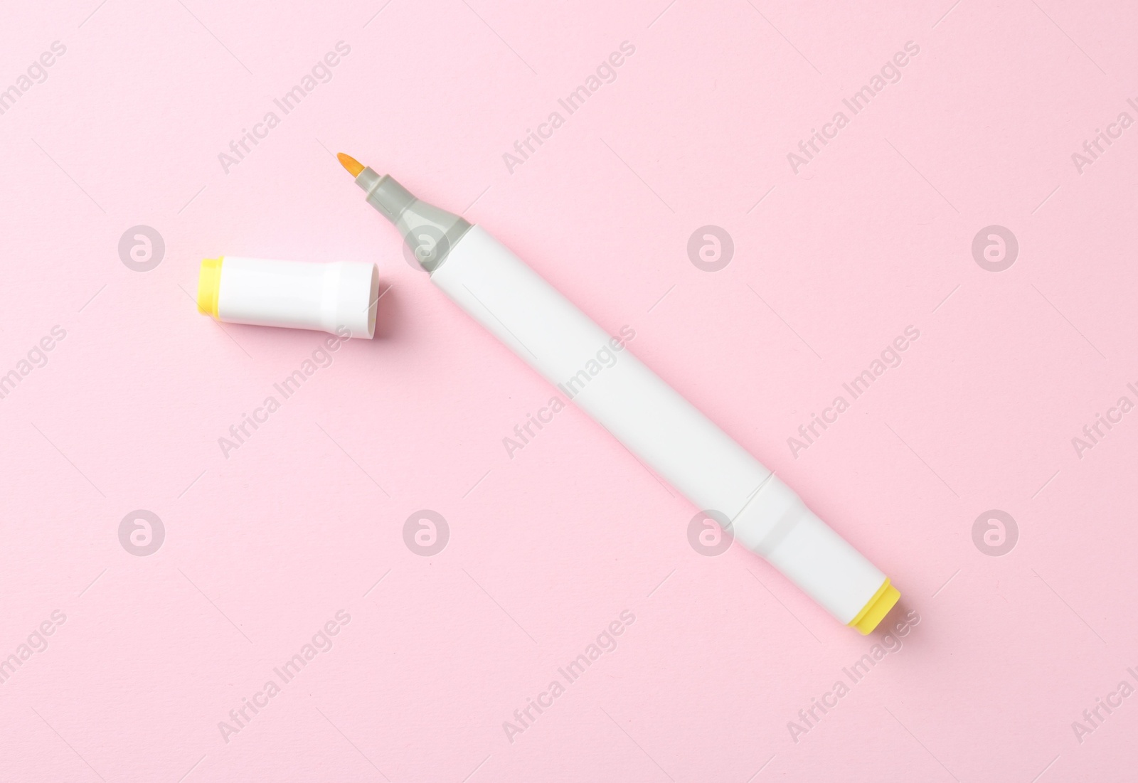 Photo of One yellow double sided marker on pink background, top view