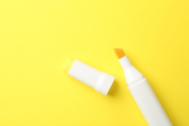 Photo of One color marker on yellow background, top view. Space for text