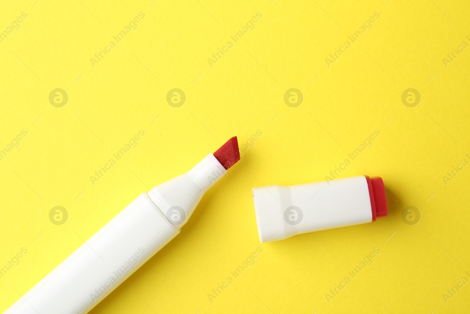 Photo of One color marker on yellow background, top view