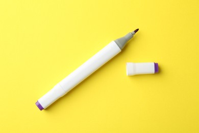 One color double sided marker on yellow background, top view