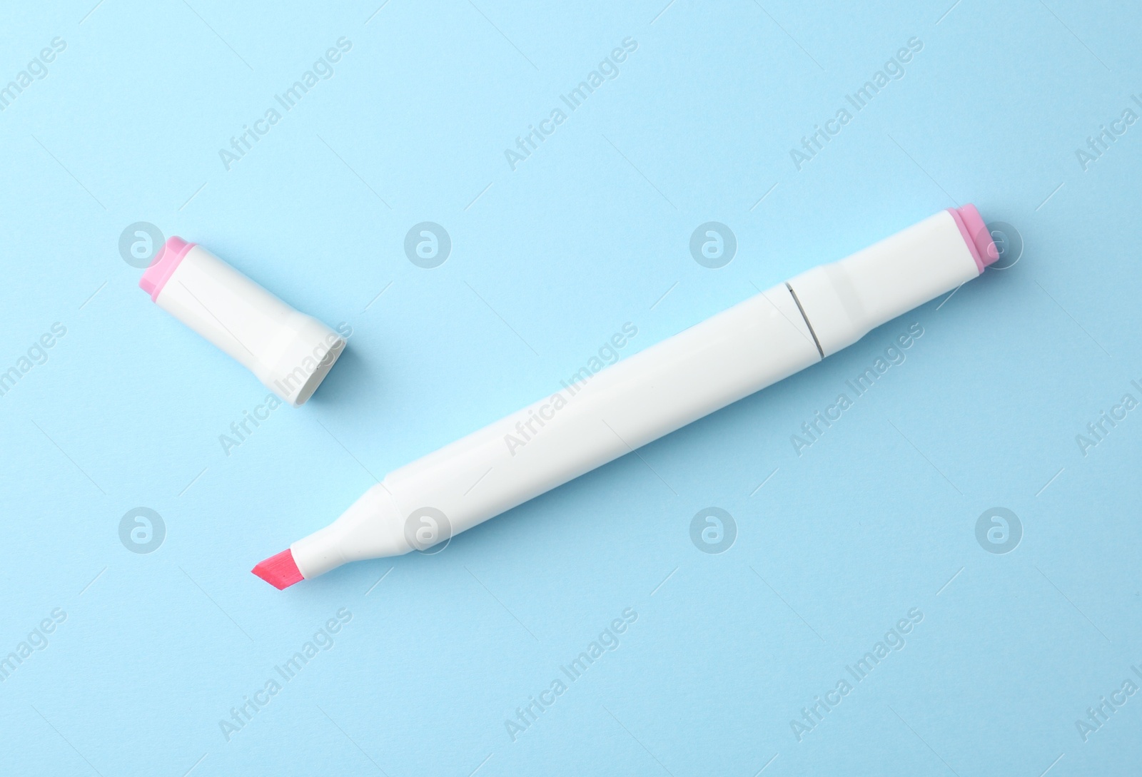 Photo of One color double sided marker on light blue background, top view