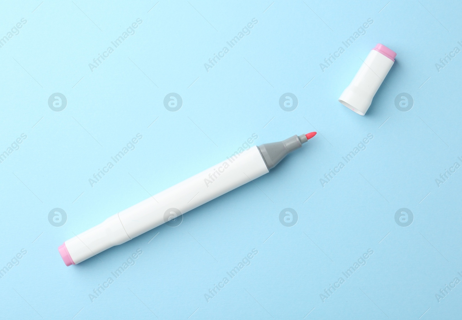 Photo of One color double sided marker on light blue background, top view