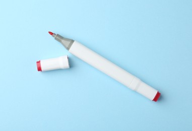 One color double sided marker on light blue background, top view