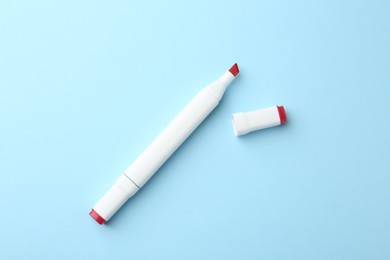 Photo of One color double sided marker on light blue background, top view