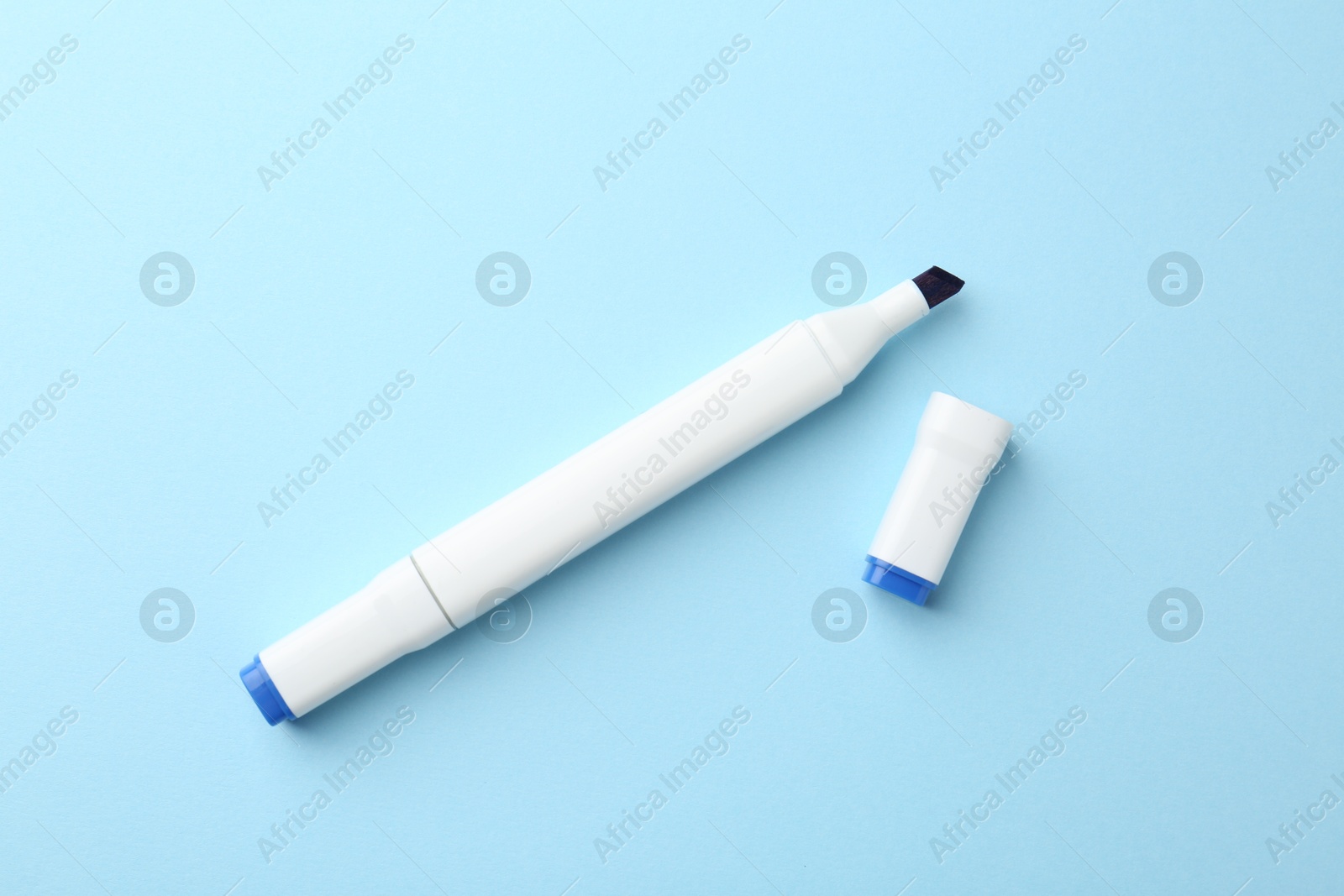 Photo of One color double sided marker on light blue background, top view