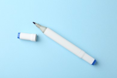 One color double sided marker on light blue background, top view