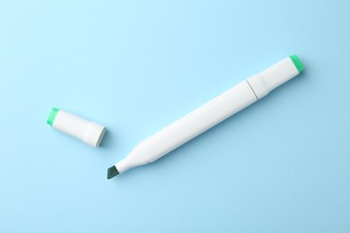 Photo of One color double sided marker on light blue background, top view