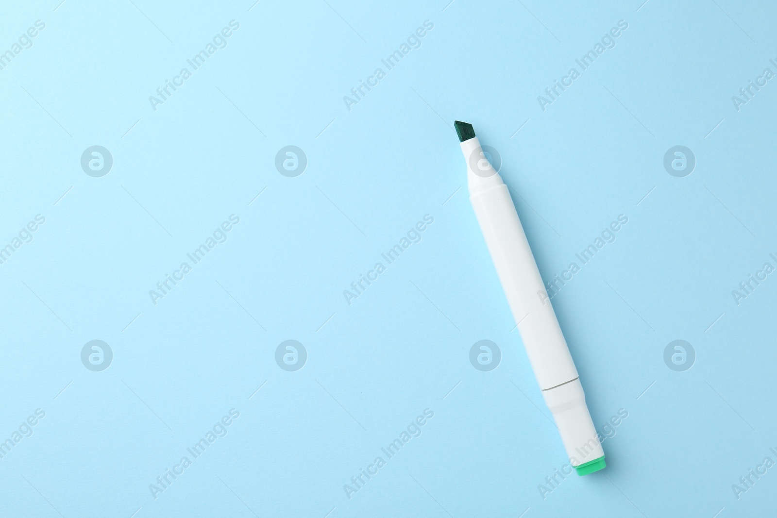 Photo of One color double sided marker on light blue background, top view. Space for text