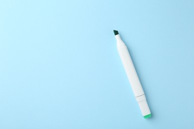 Photo of One color double sided marker on light blue background, top view. Space for text