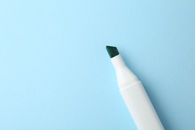 Photo of One color marker on light blue background, top view. Space for text