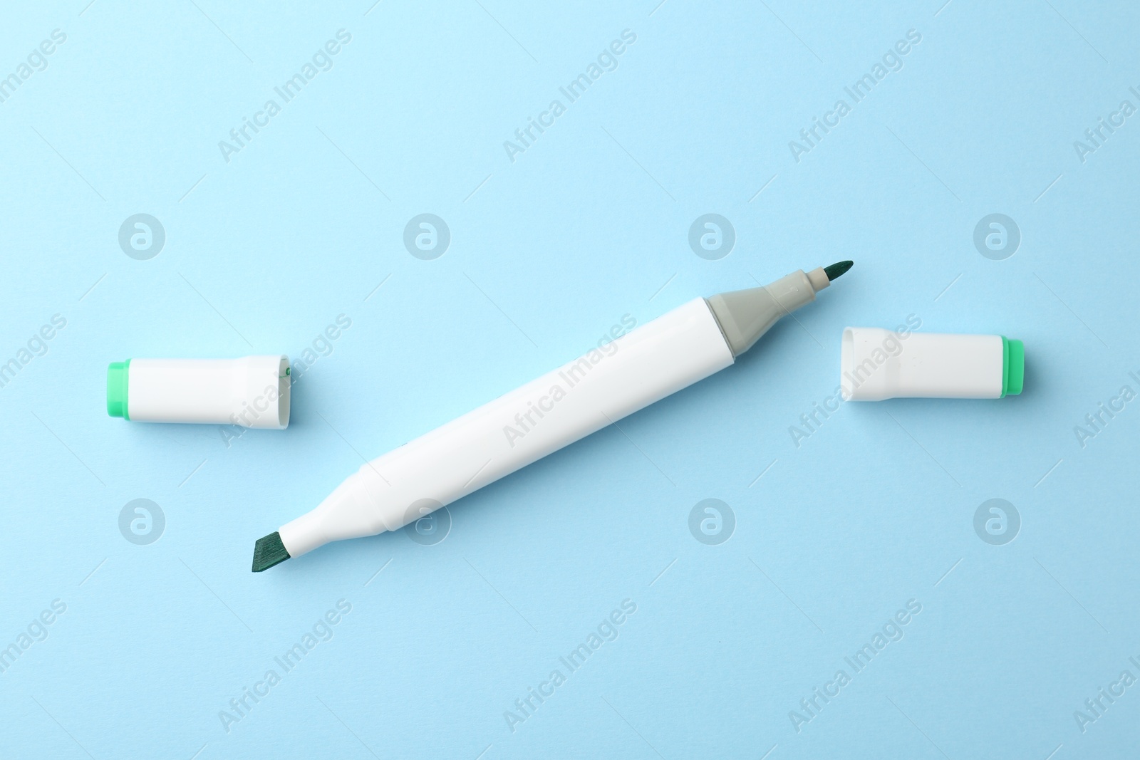 Photo of One color double sided marker on light blue background, top view