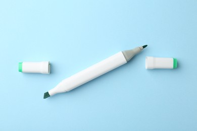 One color double sided marker on light blue background, top view