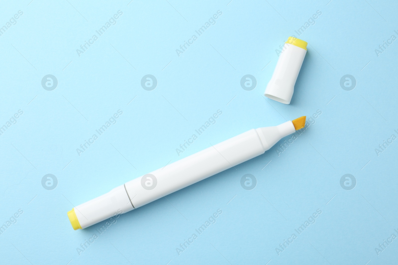 Photo of One color double sided marker on light blue background, top view