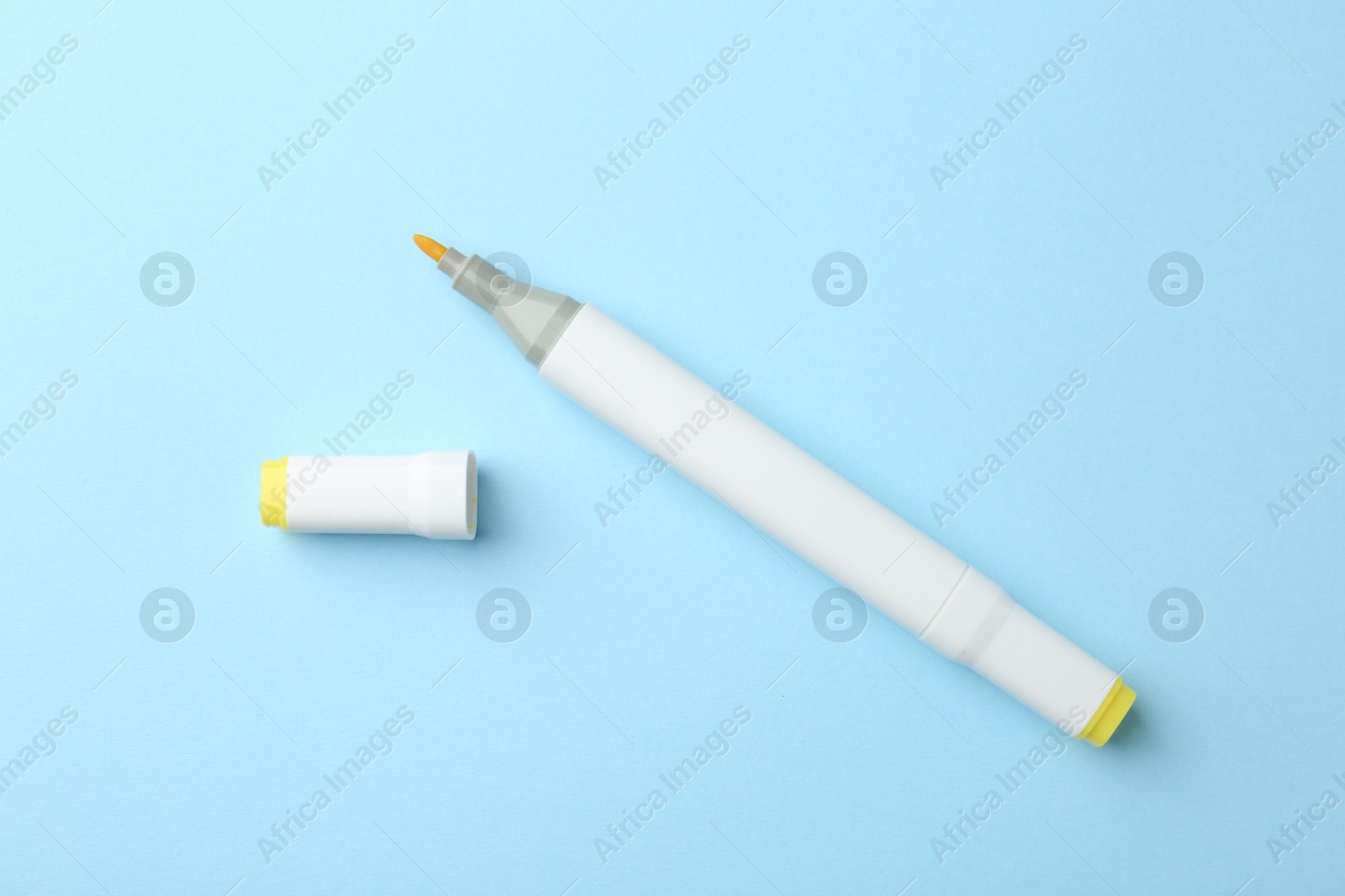 Photo of One color double sided marker on light blue background, top view