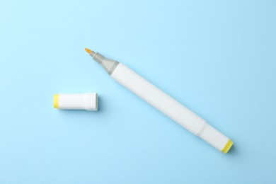 Photo of One color double sided marker on light blue background, top view