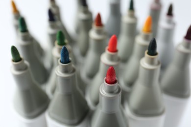 Photo of Many colorful markers on blurred background, closeup